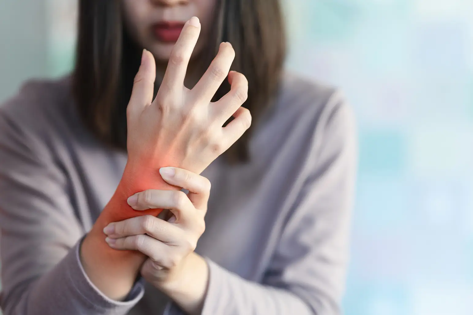person holding wrist in pain