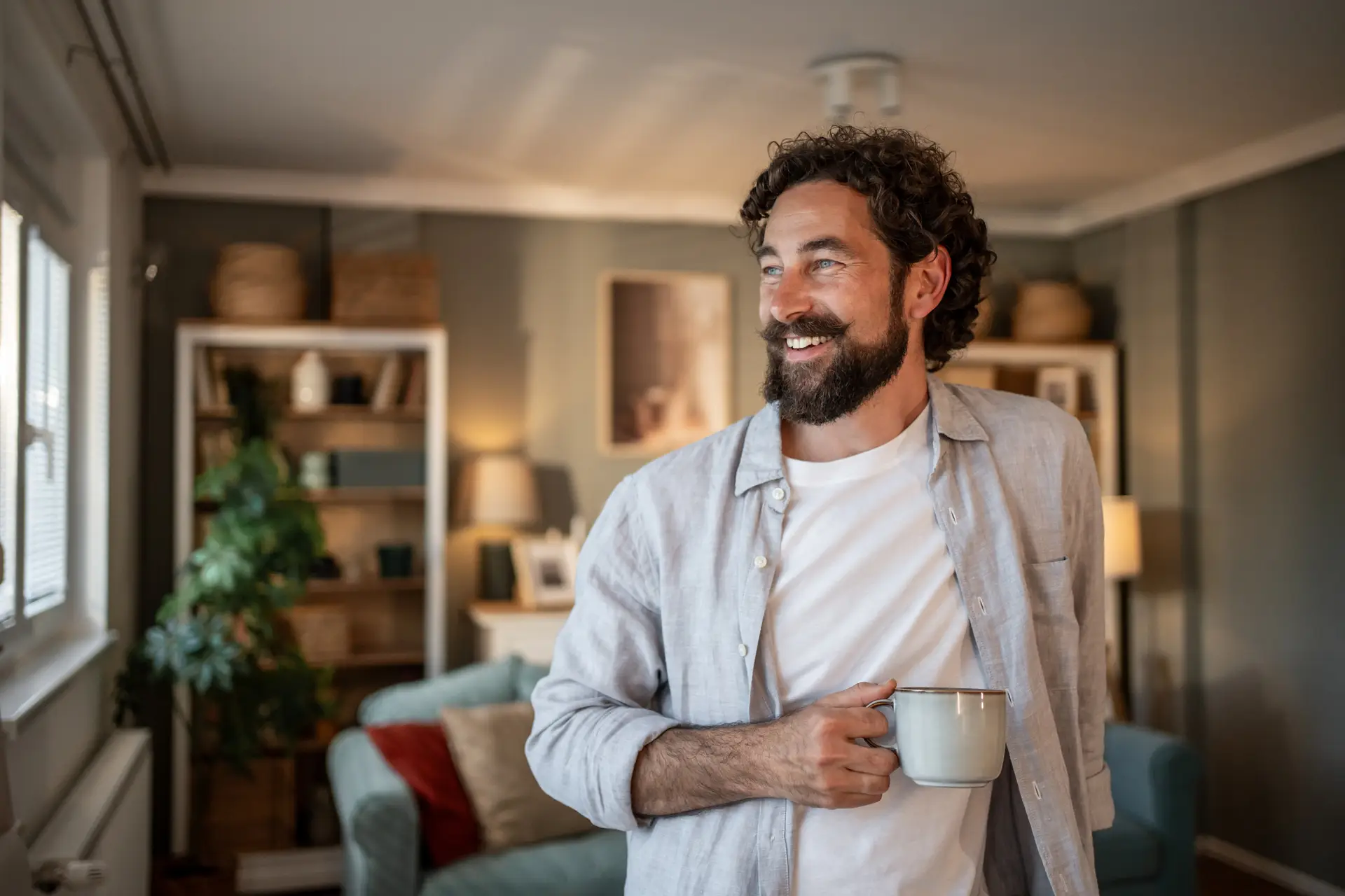 Smiling man drinking coffee and enjoying life