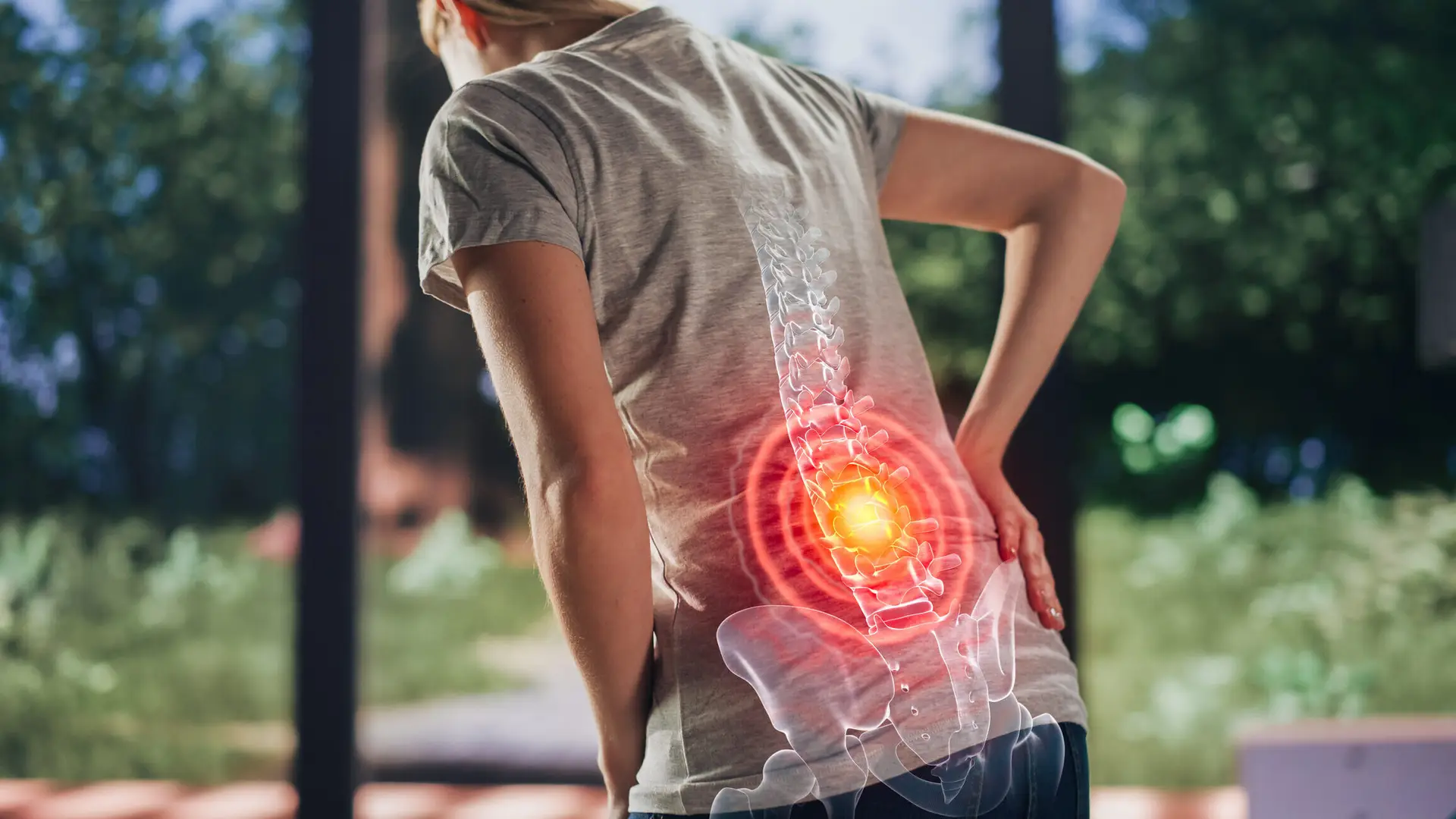 person with back pain leaning over