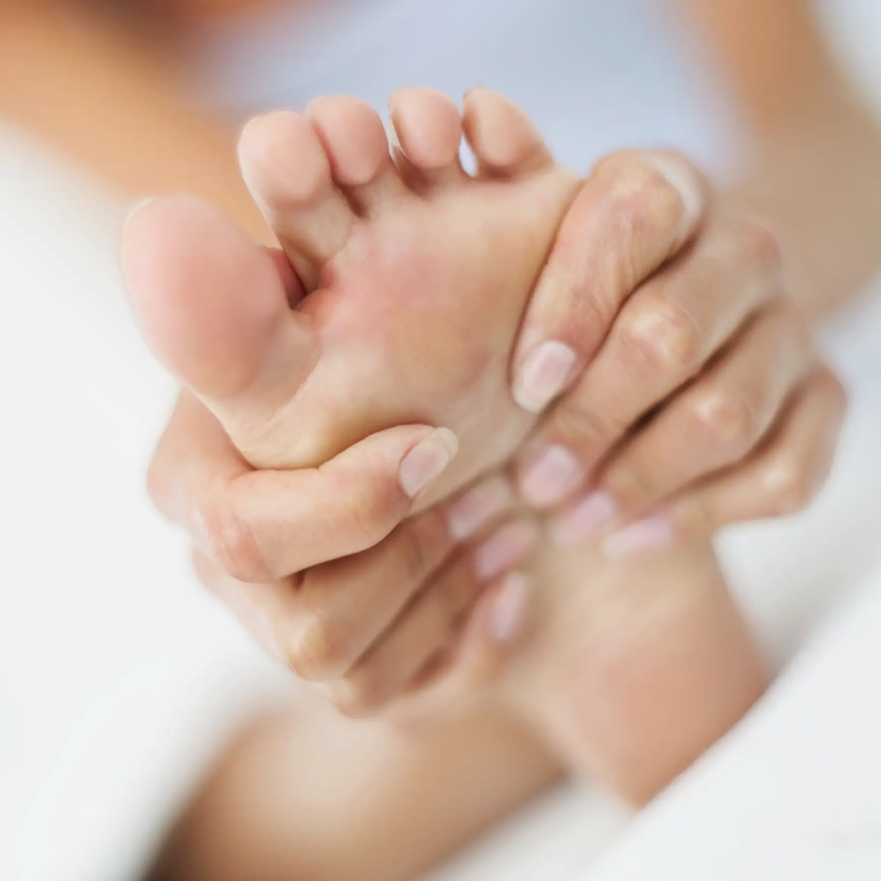 person massaging their foot