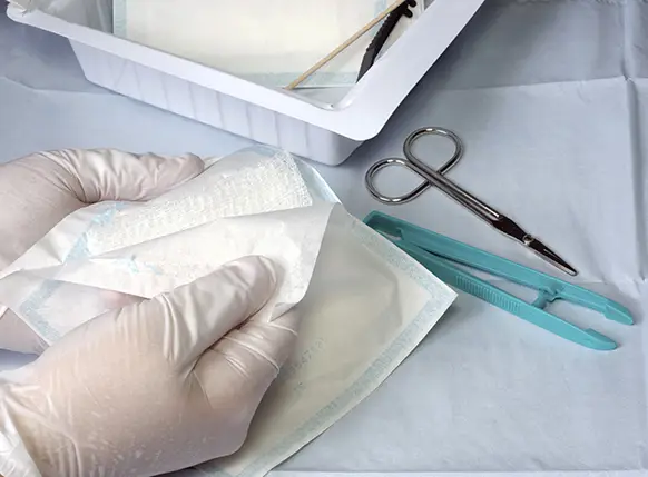opening wound dressing on table