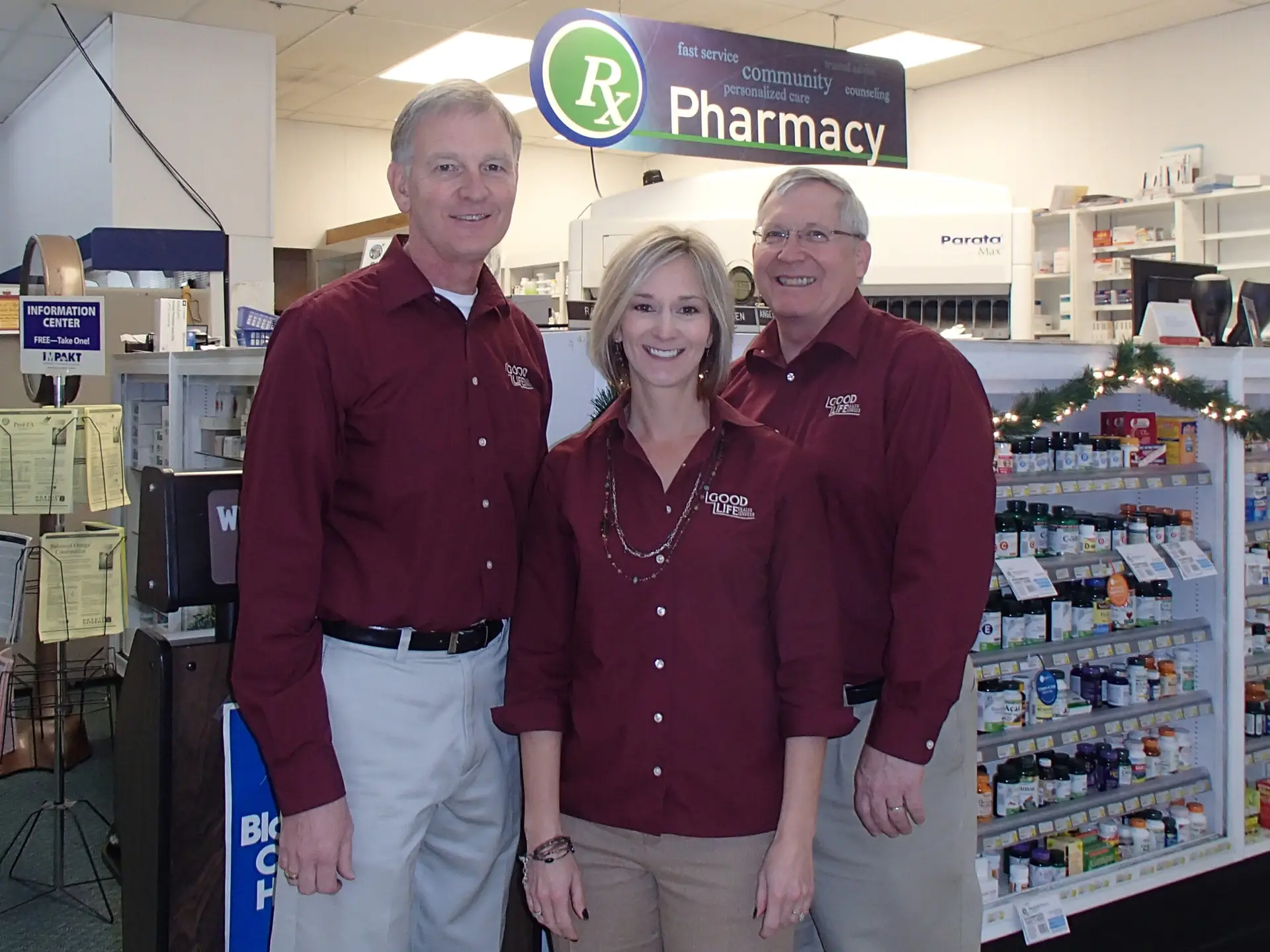 three employees of the pharmacy standing together inside the pharmacy